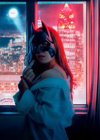 Midsection of man standing by window