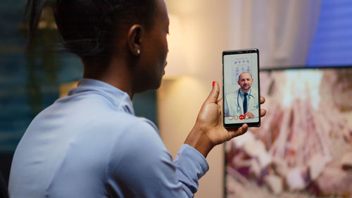 Woman talking with doctor through video call