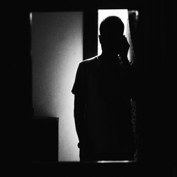 Silhouette people in darkroom