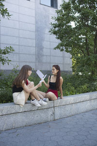 Two young women reading