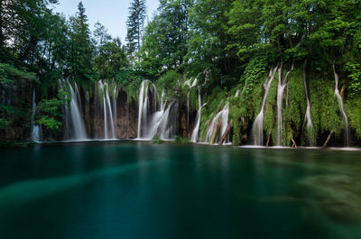Scenic view of waterfall against trees, plitvice lakes national park, croatia