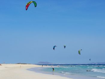 People flying over beach