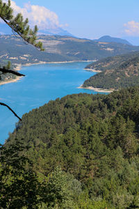Scenic view of sea and mountains against sky