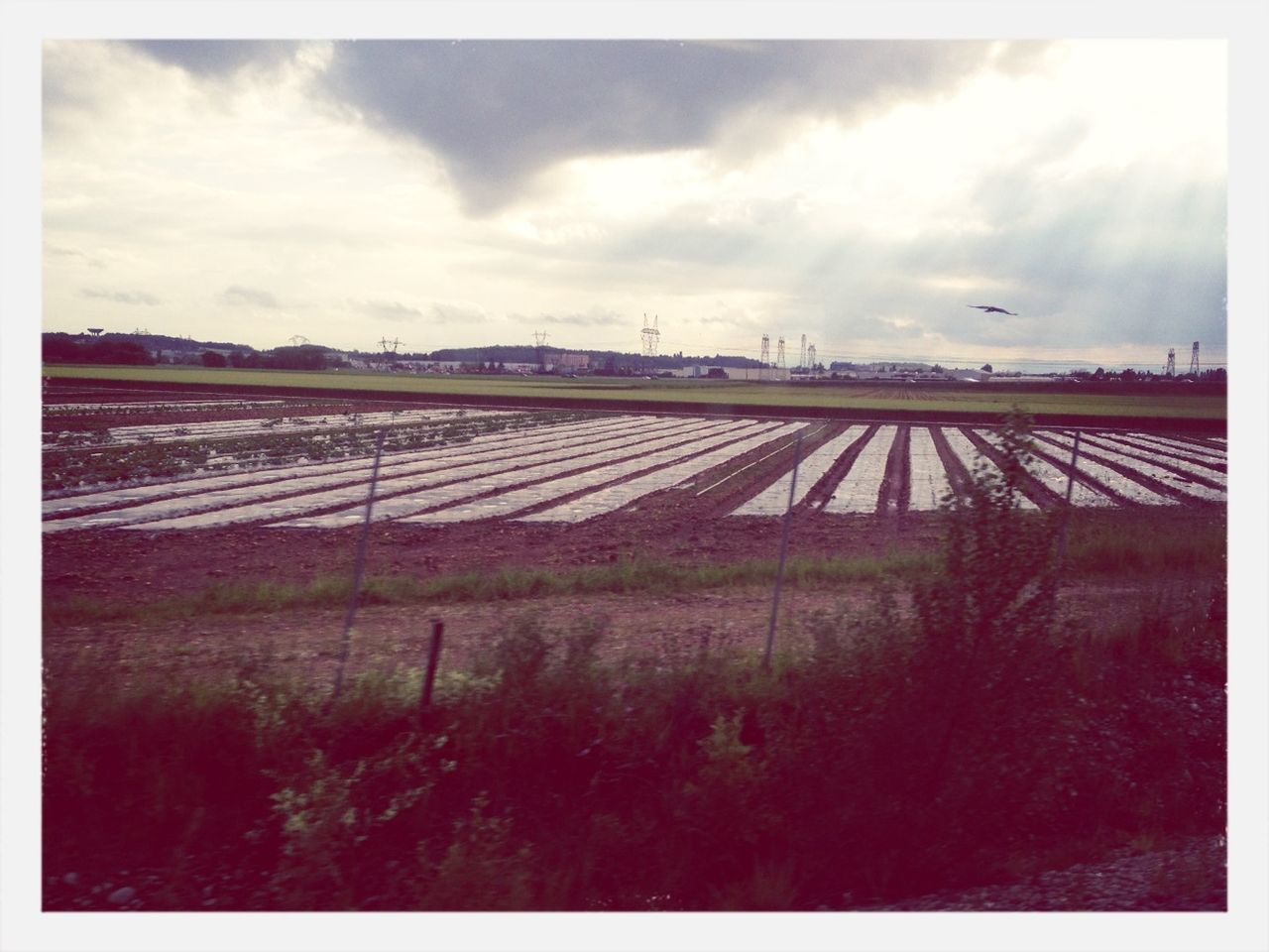 transfer print, sky, auto post production filter, cloud - sky, cloudy, built structure, cloud, architecture, field, fence, overcast, building exterior, transportation, landscape, connection, outdoors, weather, day, no people, railroad track