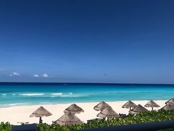 Scenic view of beach against blue sky