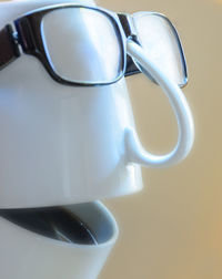 Anthropomorphic face made from coffee cups and eyeglasses