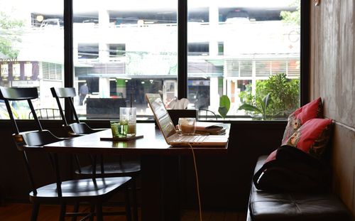 Empty chairs and table at restaurant