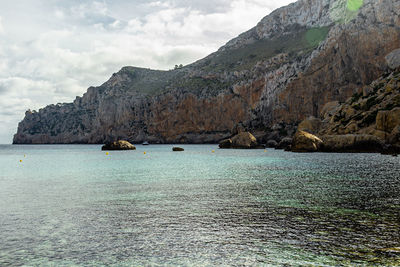 Scenic view of sea and mountains against sky