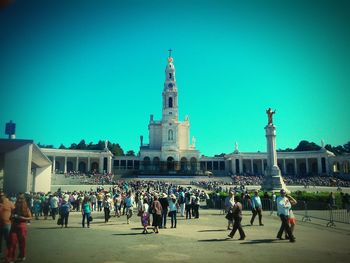 People in city against clear sky