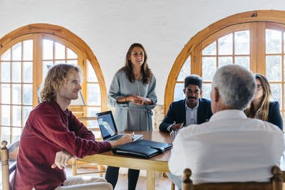 Businesswoman talking with colleague in office meeting