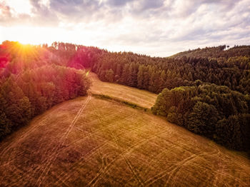 Scenic view of field against sky during sunset