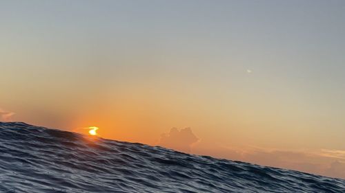 Scenic view of sea against orange sky