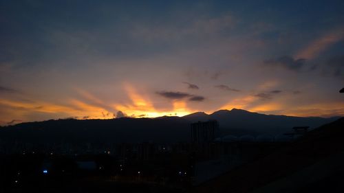 Scenic view of mountains against sky at sunset