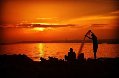 Silhouette of people at sunset