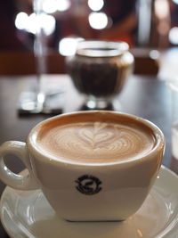 Close-up of cappuccino served on table