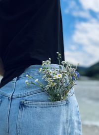 Midsection of woman holding bouquet