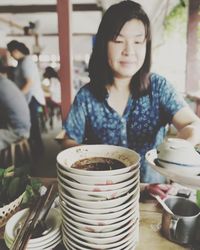 Mature woman having food while sitting in restaurant