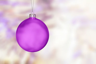 Close-up of purple balloon hanging on christmas tree