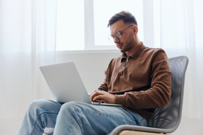 Young man using laptop at home