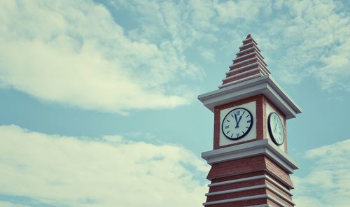 Low angle view of clock tower against sky