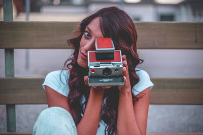 Portrait of woman photographing