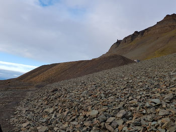 Stones on beach against sky