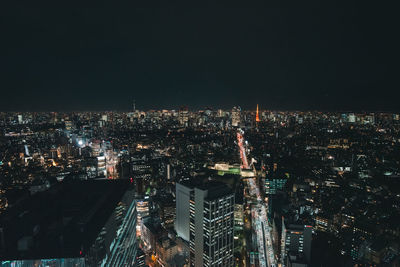 High angle view of illuminated cityscape against sky at night