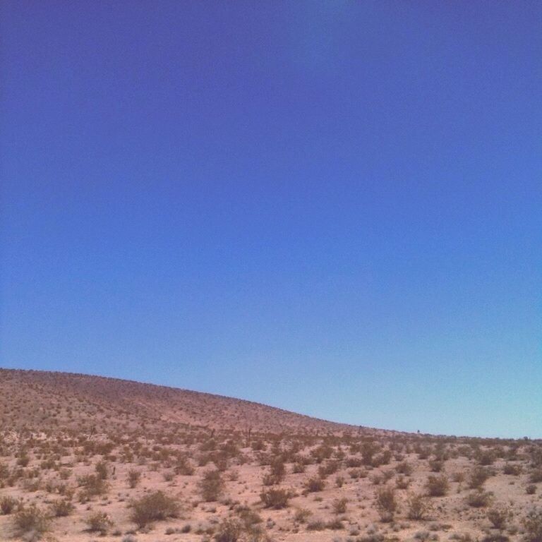 clear sky, copy space, blue, tranquility, tranquil scene, landscape, scenics, beauty in nature, nature, desert, horizon over land, non-urban scene, remote, arid climate, day, outdoors, no people, low angle view, barren, idyllic