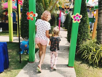 Full length of women standing on plants