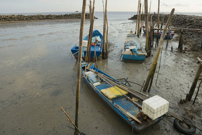 High angle view of boat moored on beach against sky