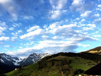 Scenic view of mountains against cloudy sky