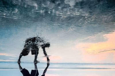 Digital composite image of silhouette at beach
