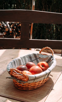 Close-up of apples in wicker basket on table