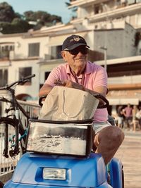 Side view of man sitting on street