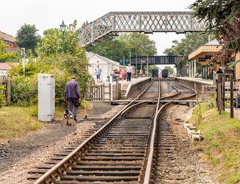 People walking on railroad track