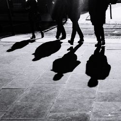 Low section of people walking on zebra crossing