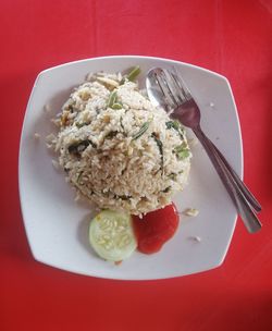 High angle view of malay cuisine fried rice called 'nasi goreng kampung' served in white plate