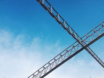 Low angle view of power lines against blue sky