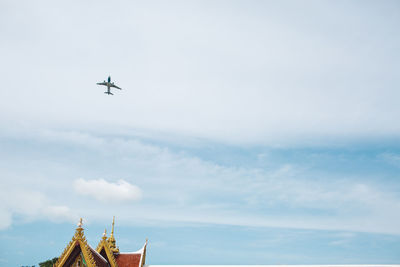 Low angle view of airplane flying in sky