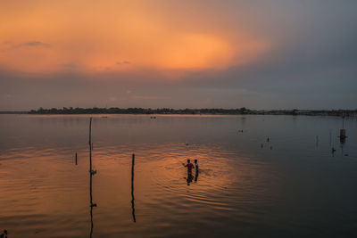 Scenic view of lake against sky during sunset