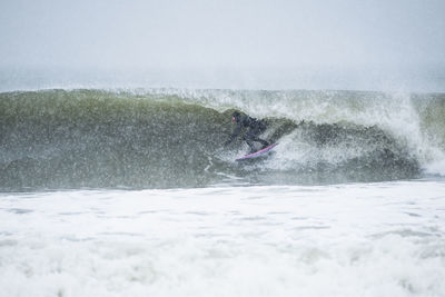 Man surfing during winter snow