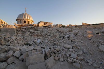 Mosque at construction site against clear sky