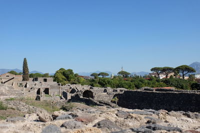 Built structure on land against clear blue sky