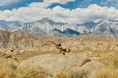 Young woman practicing yoga near alabama hills in northern california.