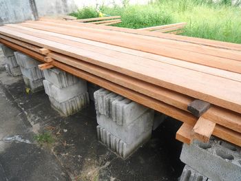 High angle view of wooden bench on field