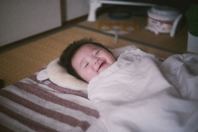 Cute baby sleeping on bed at home