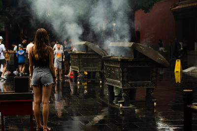 Rear view of woman standing in city