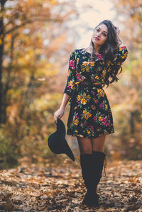 Young woman with umbrella in autumn