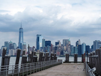 View of cityscape against cloudy sky