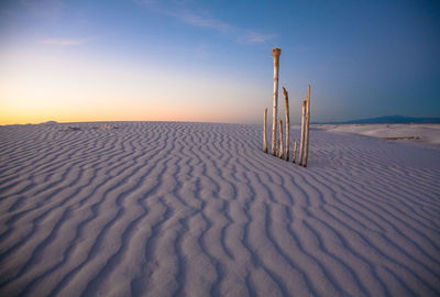 Scenic view of sand dune against sky